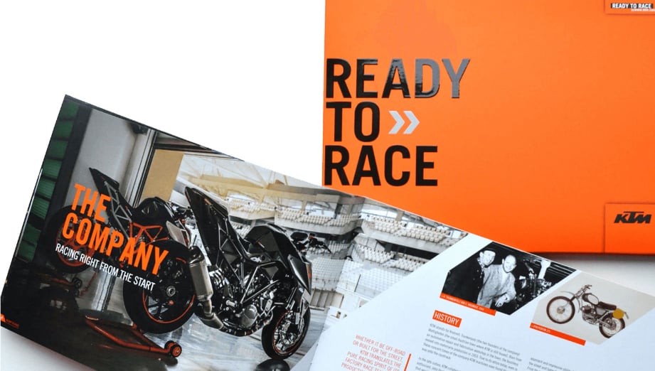KTM printed brochure cover and spreads