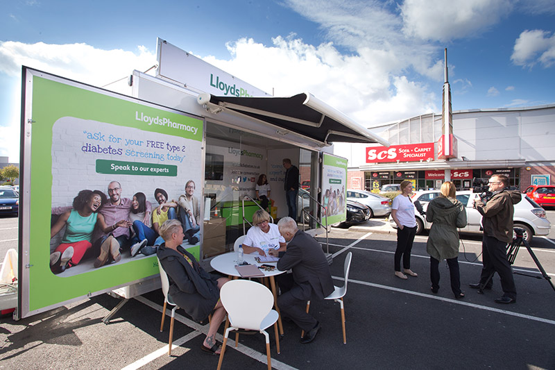 Roadshow trailer with people at table in Castle Vale