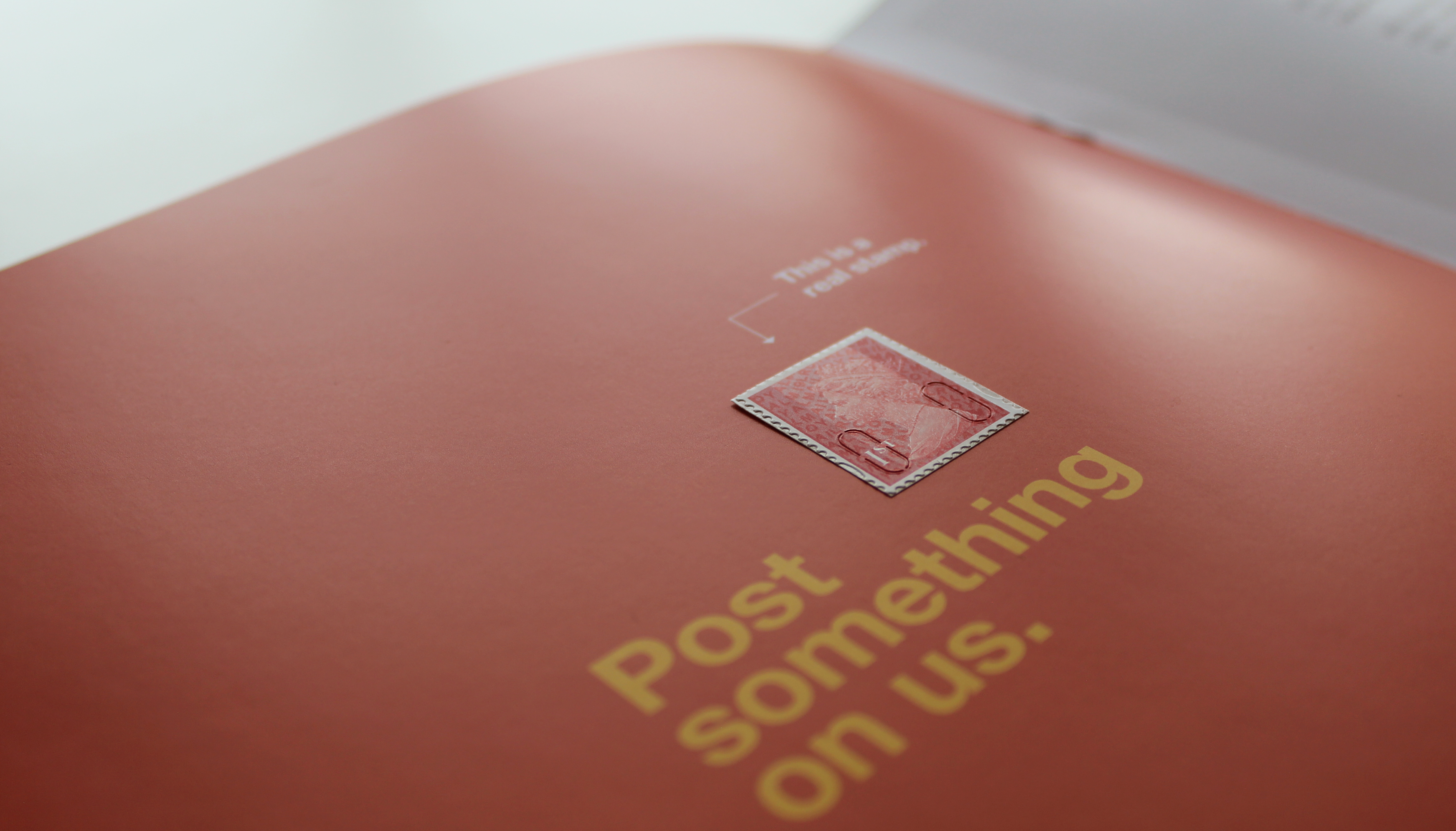 Printed brochure with 1st Class postage stamp saying mail something on us