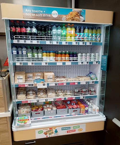 Tesco cafe chiller cabinet with printed promotional graphics